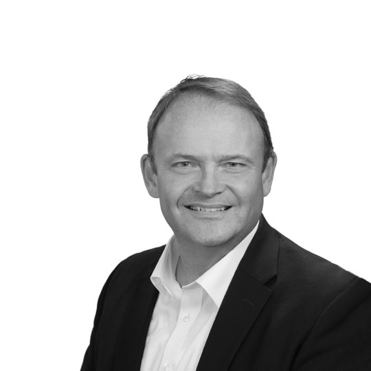 Black and white image of man in dark suit and white shirt