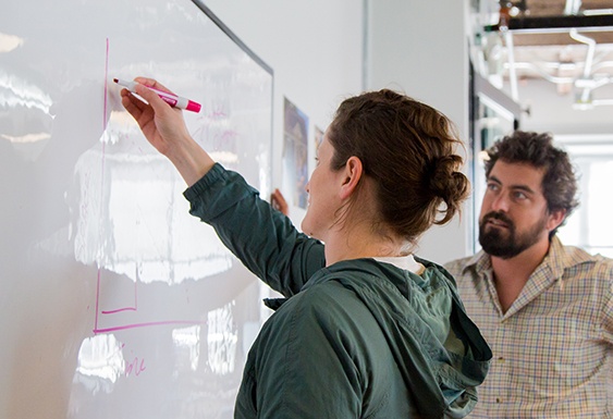Solar cleantech workers at a whiteboard