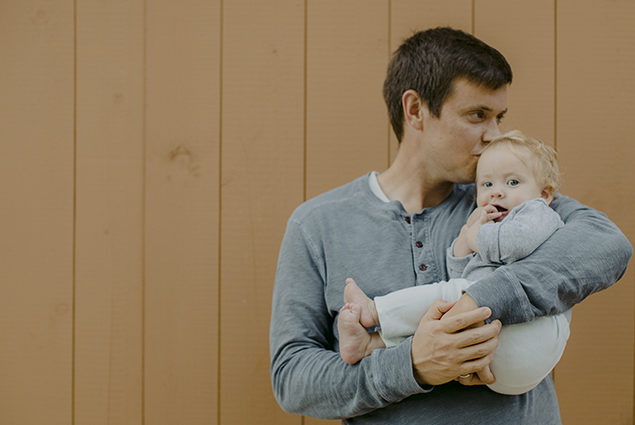 A father holding a baby